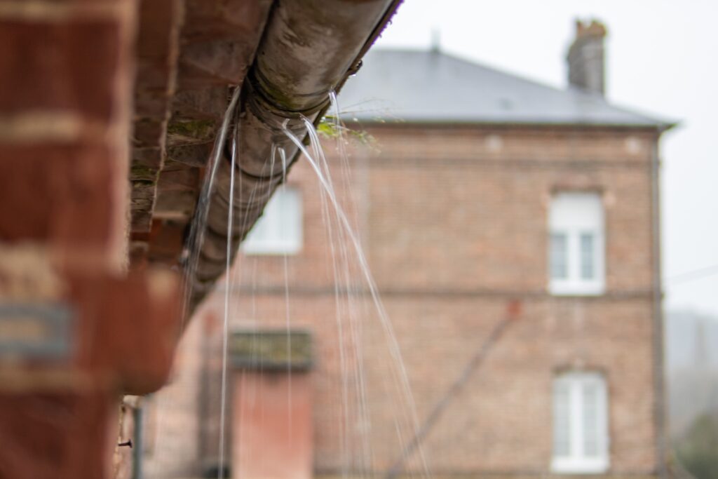 A leaking gutter in North Carolina needing gutter management services.